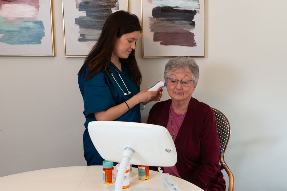 nurse taking patient's temperature