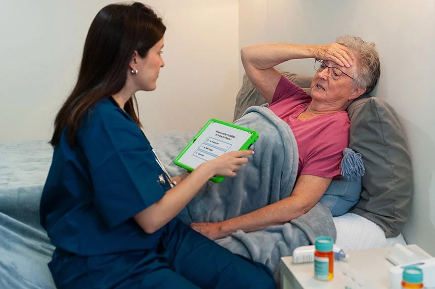 Nurse on tablet with patient